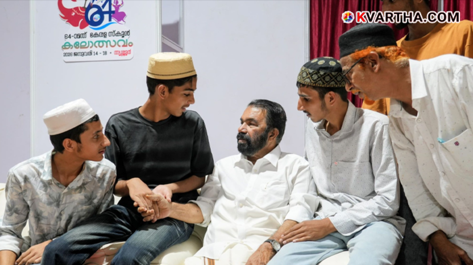 Kashmiri students from Markaz School posing with Kerala Education Minister V. Sivankutty at the Kalolsavam venue.