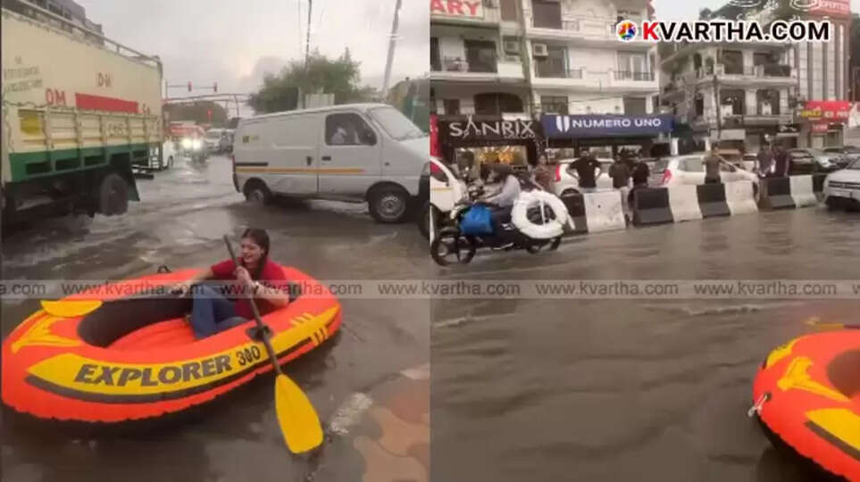 Man traveling in an inflatable boat through flooded streets of Delhi