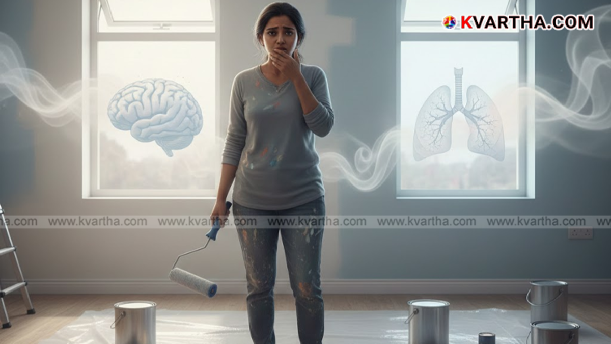  A worker painting a wall with hazardous fumes warning