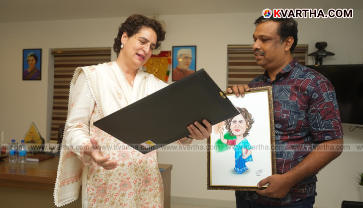 Cartoonist Basheer Kizhisery presents caricature to Priyanka Gandhi in Wayanad.