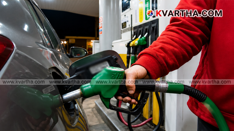 A digital price screen and fuel dispenser nozzle at a busy Indian retail petrol pump station indicating current fuel rates.
