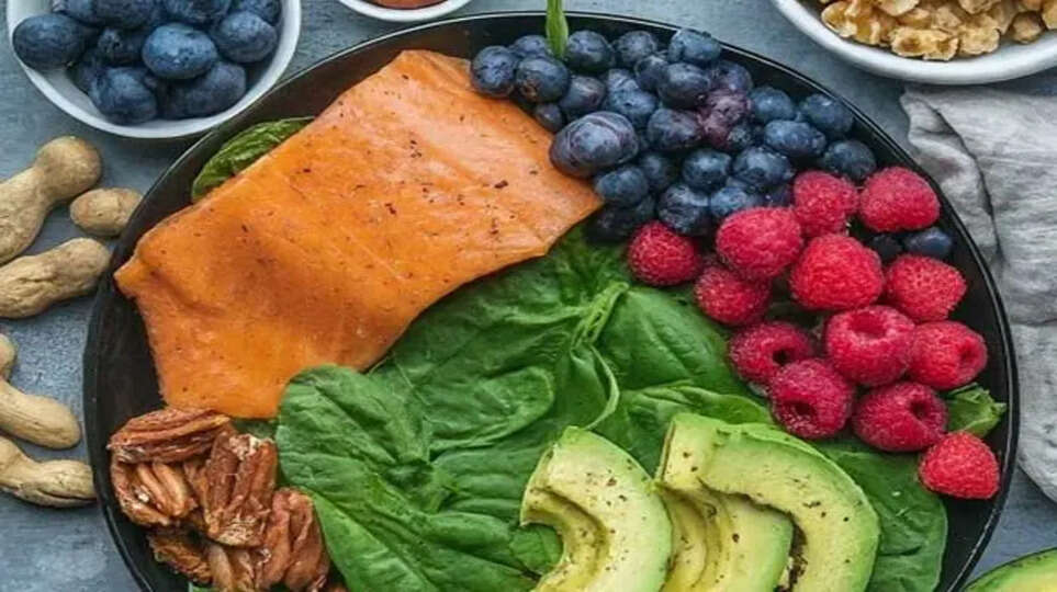 A collage of various anti-inflammatory foods like turmeric, fish, berries, and avocado.