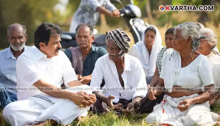 KC Venugopal listening to farmers in a paddy field in Palakkad.