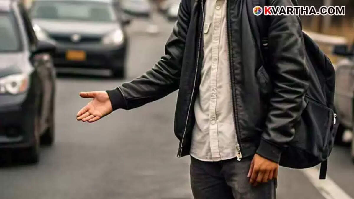 A student hitchhiking on a roadside