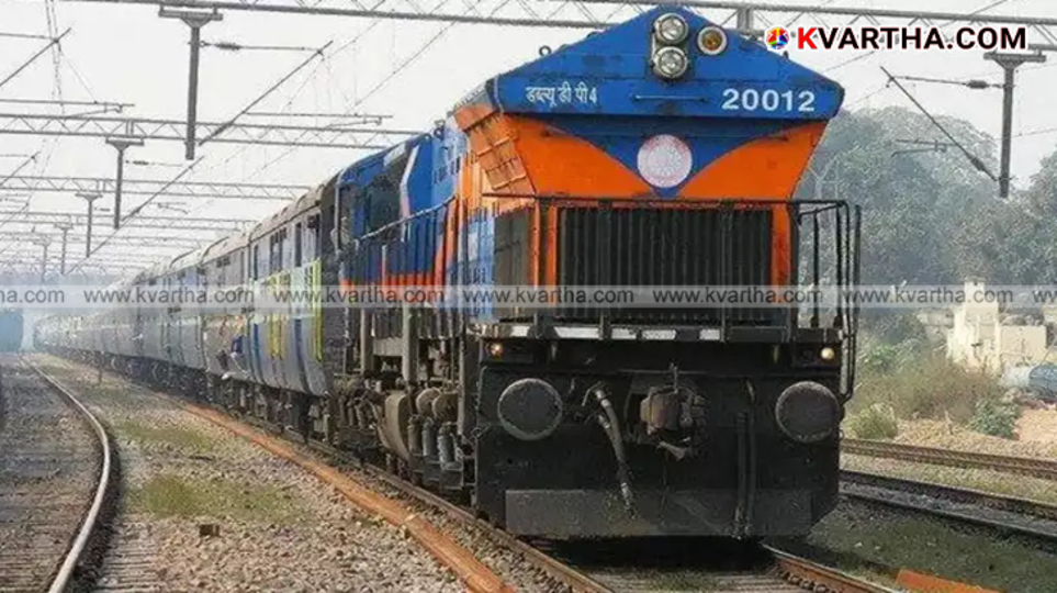 Indian railway train arriving at a station in Kerala