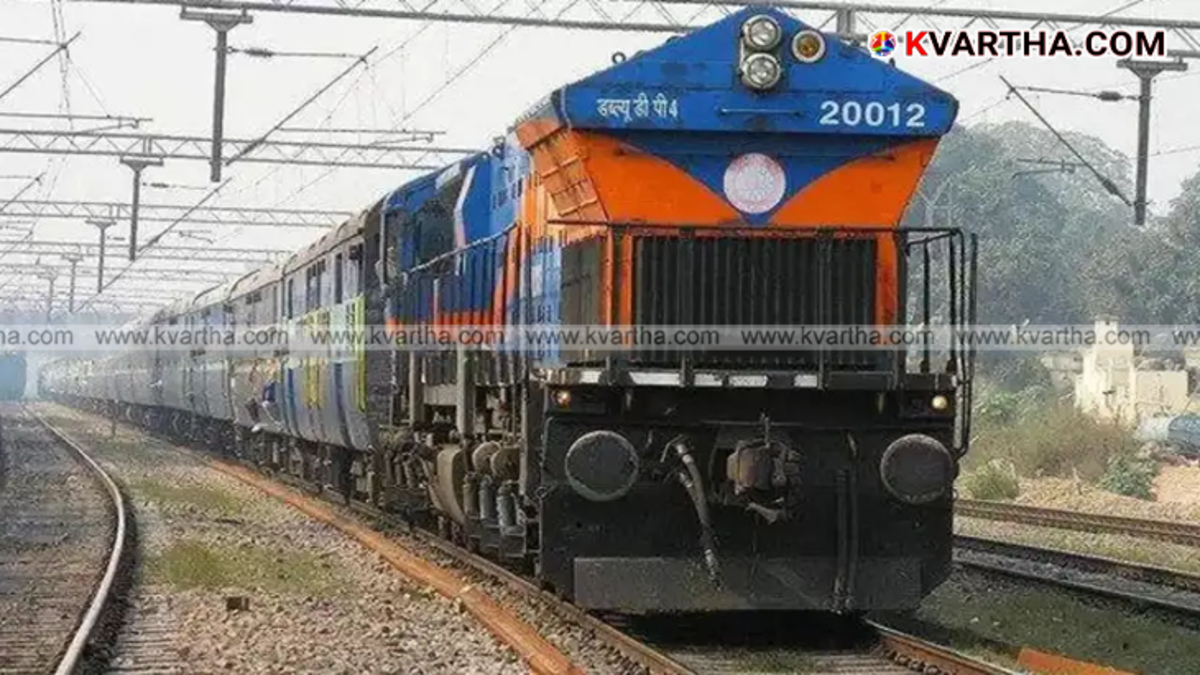 Indian railway train arriving at a station in Kerala
