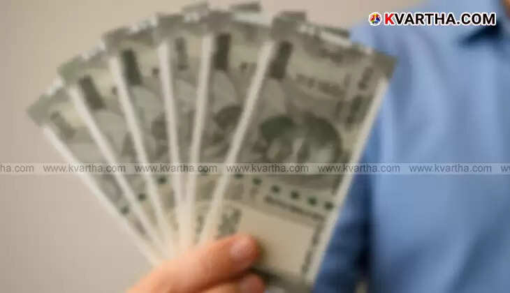 Hand placing cash into a bank deposit machine or counter.