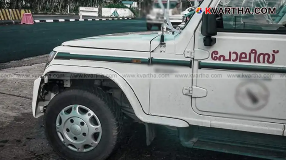 Kerala police vehicle parked outside a police station.