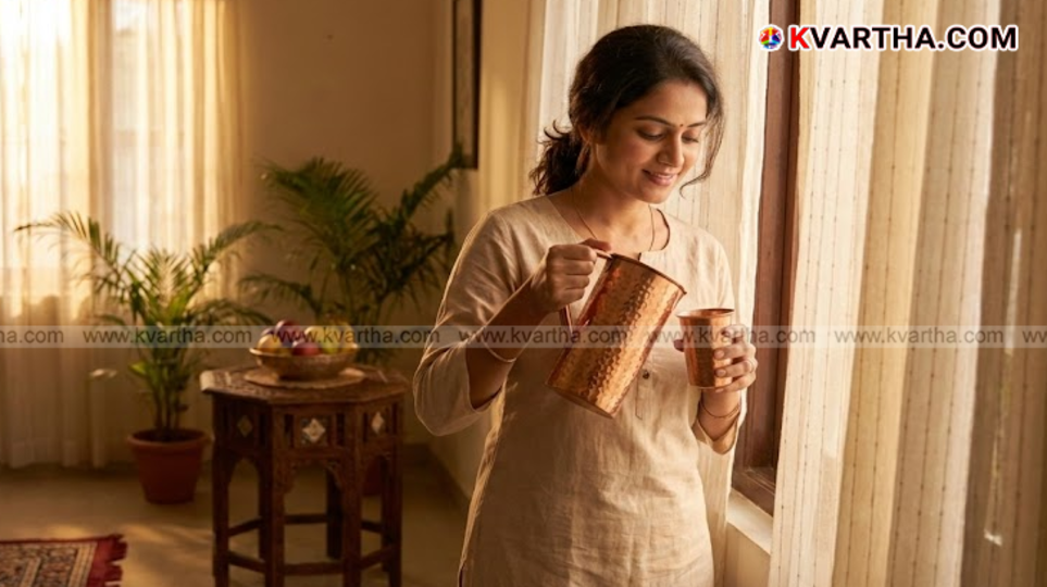 A copper jug and glass filled with water on a wooden table.