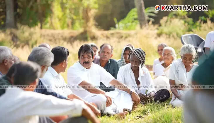 KC Venugopal listening to farmers in a paddy field in Palakkad.