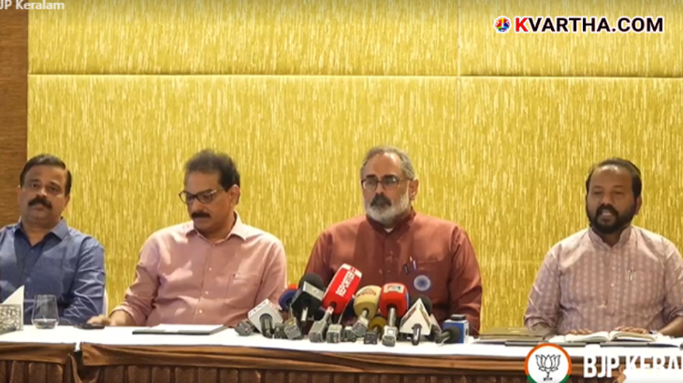  Sabu M. Jacob and Rajeev Chandrasekhar holding hands at a press conference.