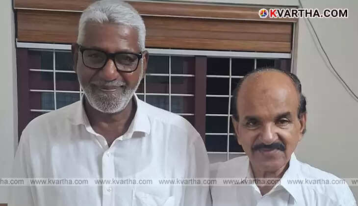 Kookanam Rahman handing a book to M K Ibrahim.