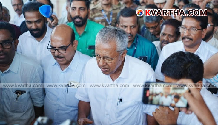 Senior CPM leader Pinarayi Vijayan stepping out of the Kannur International Airport in Mattannur, surrounded by cheering party cadres holding red flags.
