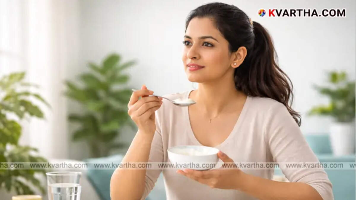 A woman wearing lipstick while&nbsp;eating yogurt.