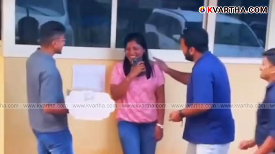  A group of people celebrating a birthday in front of the Kannur Police Headquarters.