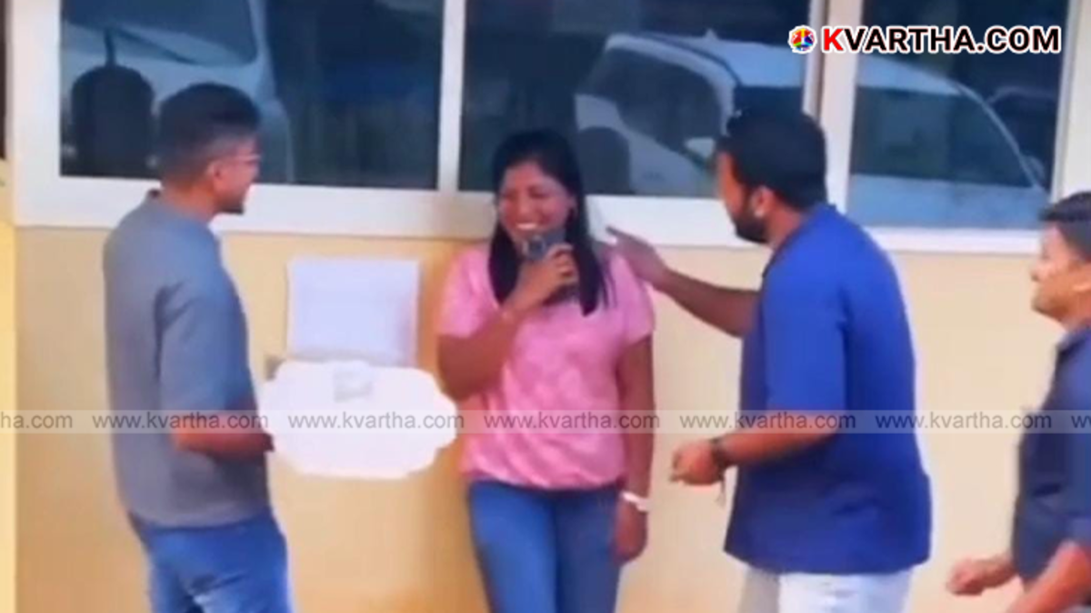  A group of people celebrating a birthday in front of the Kannur Police Headquarters.