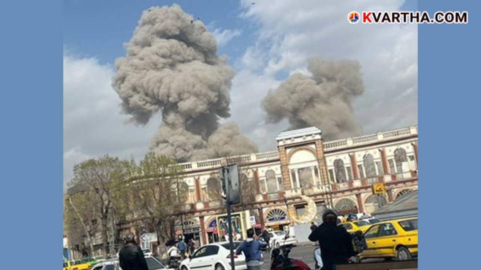 Explosions and thick smoke rising from buildings in an urban area during a night raid.