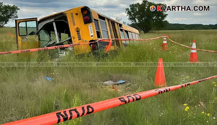 A yellow school bus overturned in a muddy field after an accident in Nagaroor, Kerala.