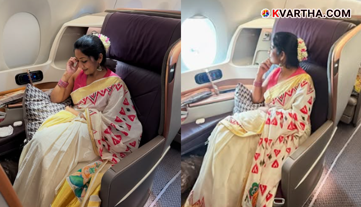 Actress Navya Nair smiling with a jasmine flower.