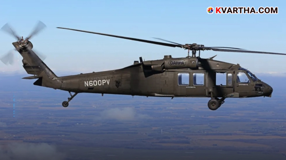  A US Black Hawk helicopter flying over rugged terrain.
