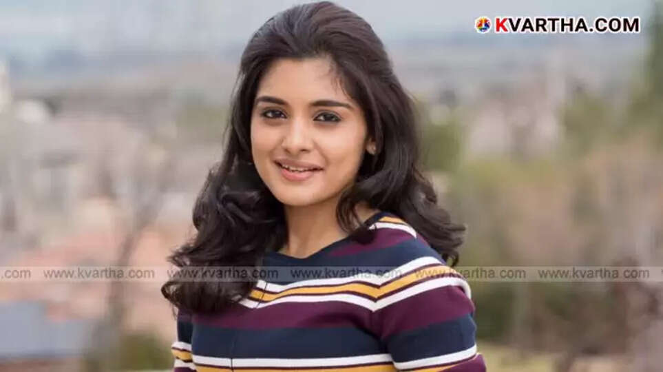 Portrait of Niveditha Thomas, a young Indian actress, smiling.