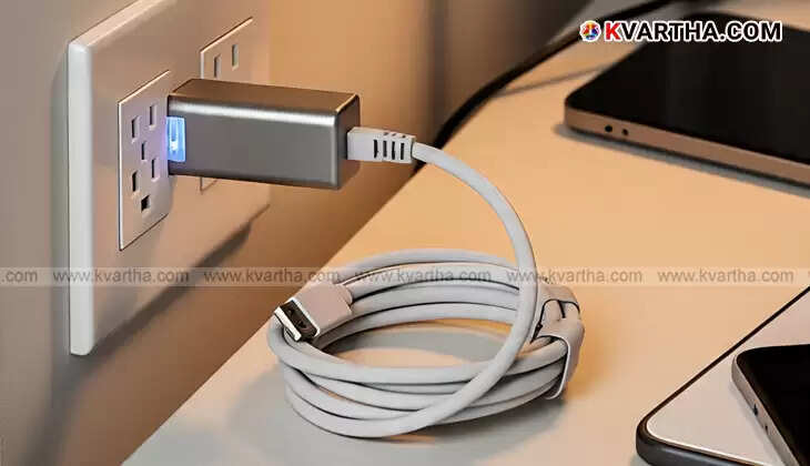  A mobile phone charger plugged into a wall socket without a device connected, illustrating idle power consumption.
