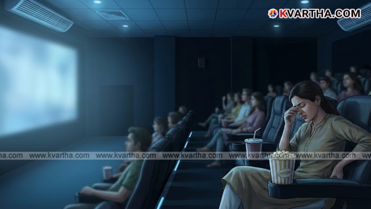 Audience watching a movie in a dark theater with a bright screen.