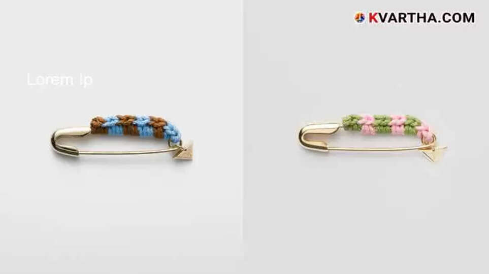 Prada safety pin brooch with thread detail and charm.