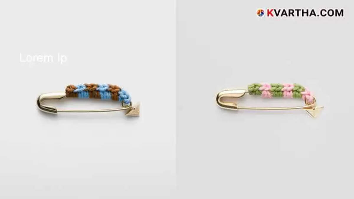 Prada safety pin brooch with thread detail and charm.