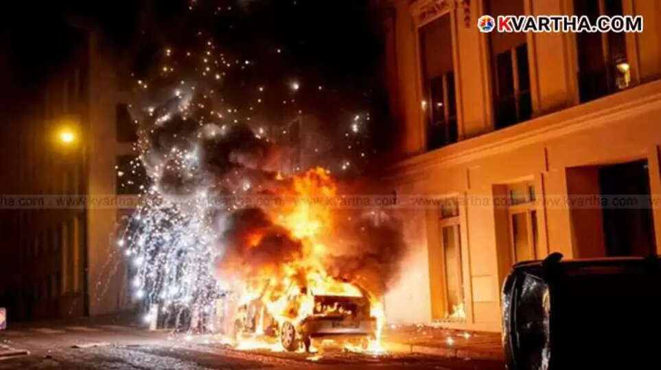 Chaotic scenes on Champs-&Eacute;lys&eacute;es in Paris after PSG's Champions League victory, with smoke and damaged vehicles.