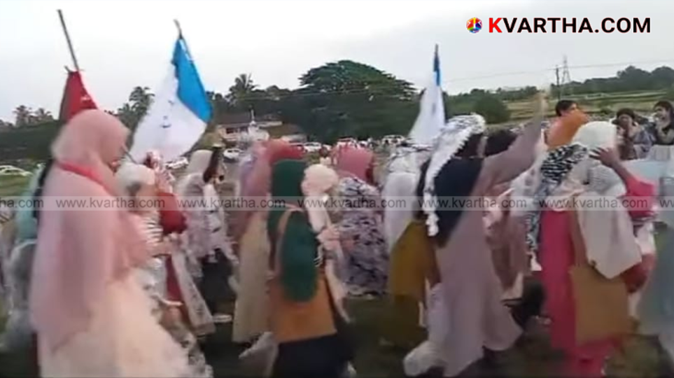 A group of people holding flags, representing a political demonstration. This is a symbolic image of the protest in Madayippara.