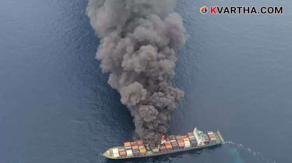 Large cargo ship engulfed in flames with smoke billowing, visible from a distance off the Kerala coast.
