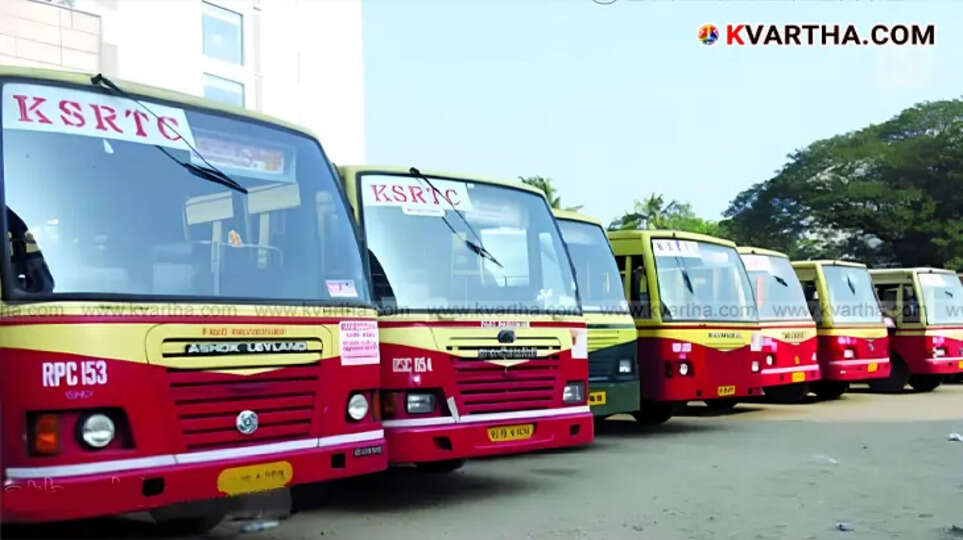 A KSRTC bus on a road in Kerala with people waiting at a bus stop.