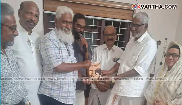 Kookanam Rahman handing a book to M K Ibrahim.