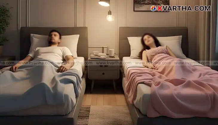 Couple sleeping in separate beds