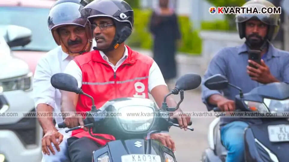  KC Venugopal MP riding pillion with a Swiggy delivery executive in Thiruvananthapuram.