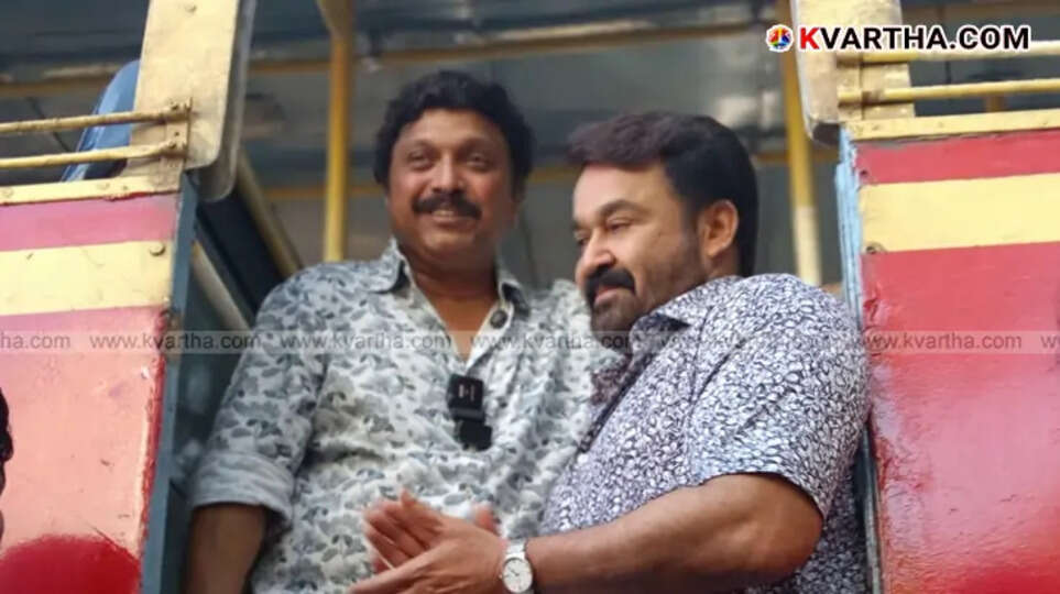 Malayalam actor Mohanlal standing beside a new KSRTC bus.