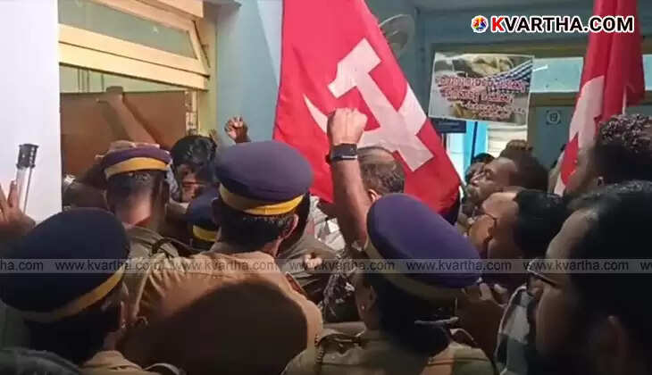 Protesters holding placards and flags outside Kannur Corporation office concerning the street dog menace.