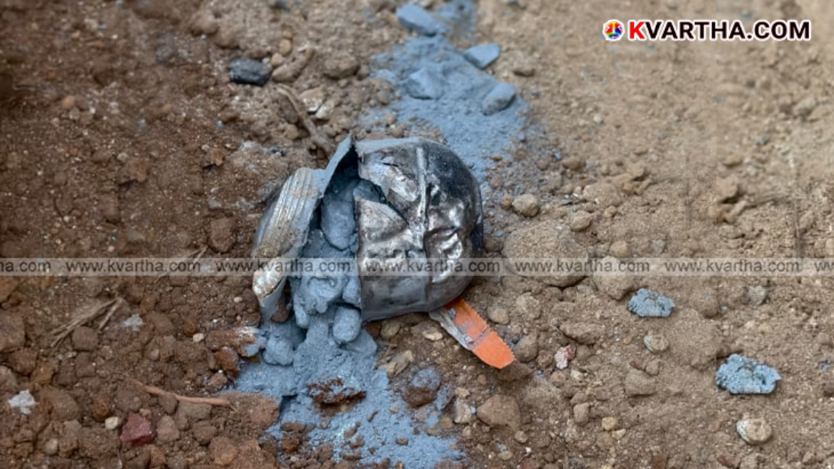 Police officers inspecting the site of a bomb explosion in Poyiloor, Kannur.
