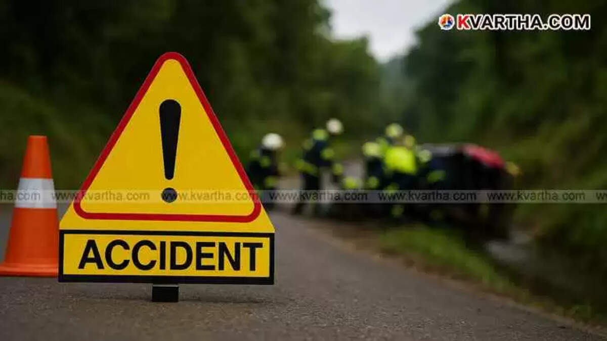 An accident warning sign on a roadside with blurred emergency responders assisting an overturned auto rickshaw in the background.