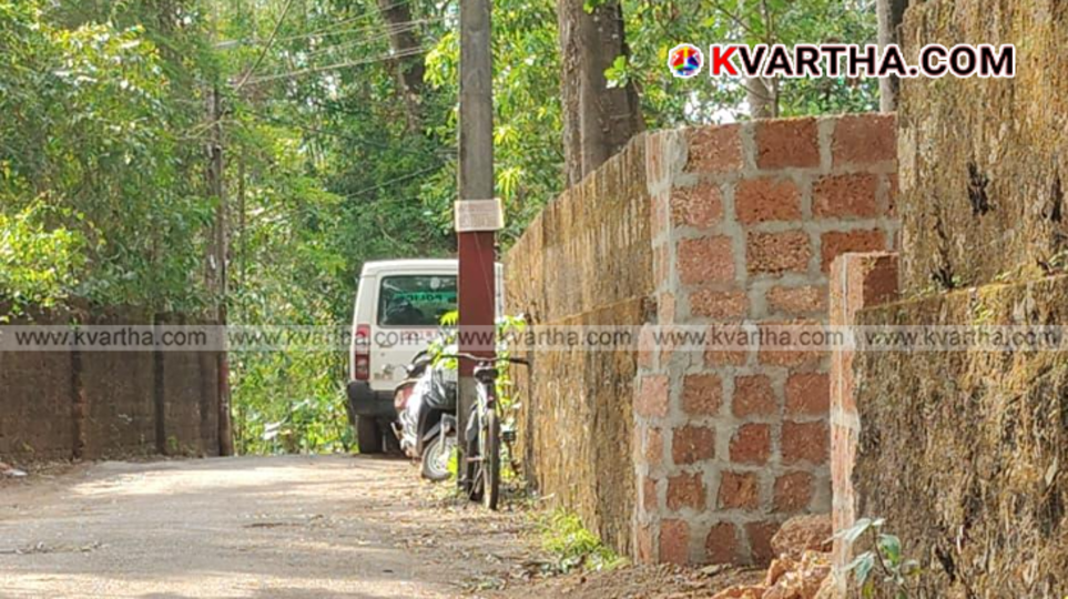 A Kerala Police patrol vehicle parked along a narrow rural highway stretch during official surveillance operations.