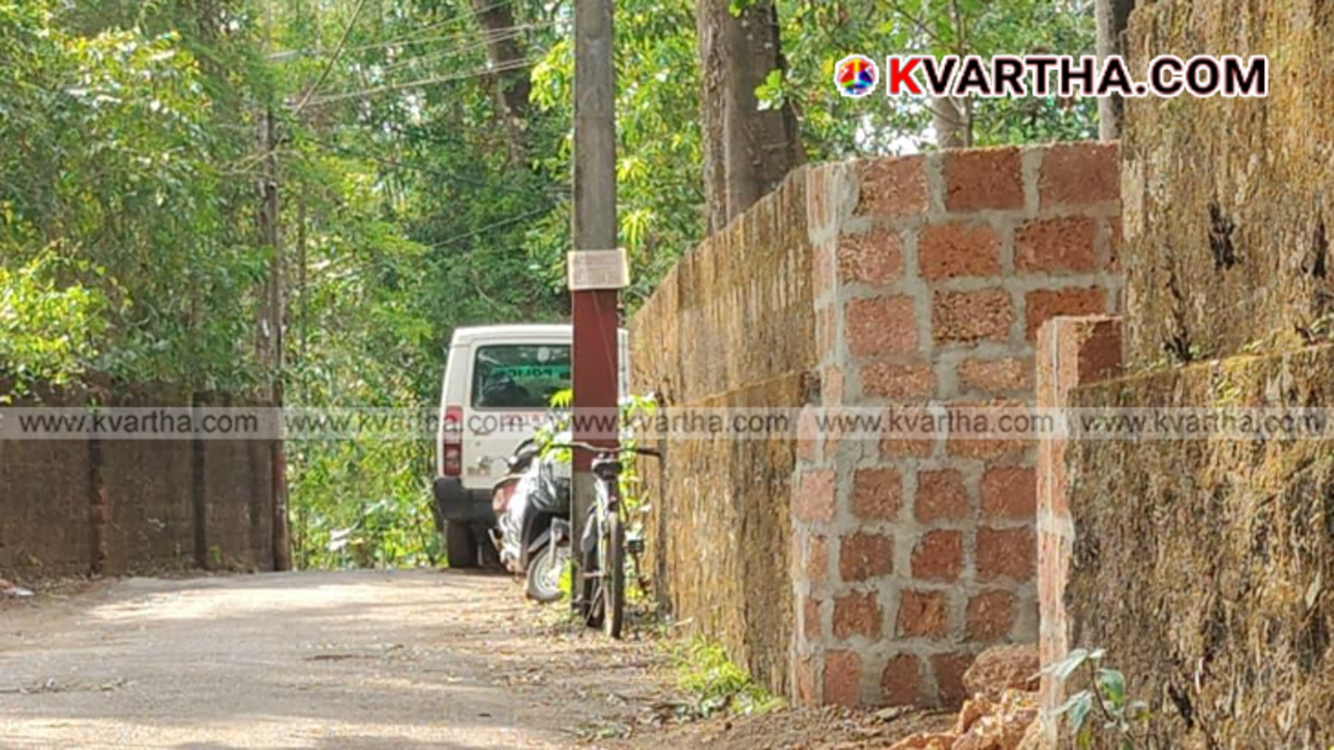 A Kerala Police patrol vehicle parked along a narrow rural highway stretch during official surveillance operations.