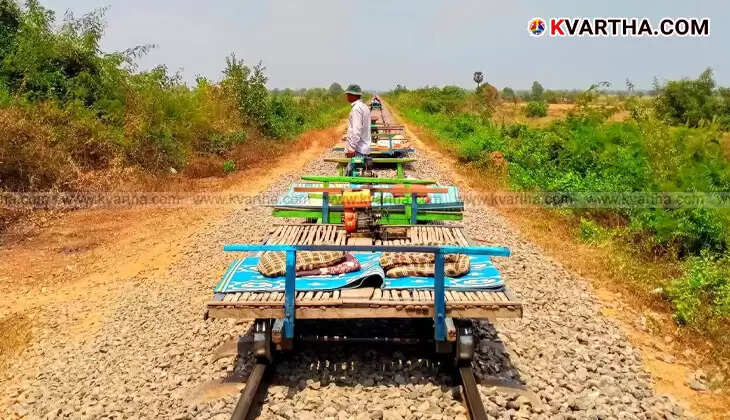 Tourists riding Cambodia's bamboo train on a rural railway track