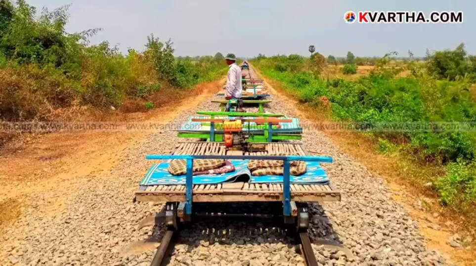 Tourists riding Cambodia's bamboo train on a rural railway track