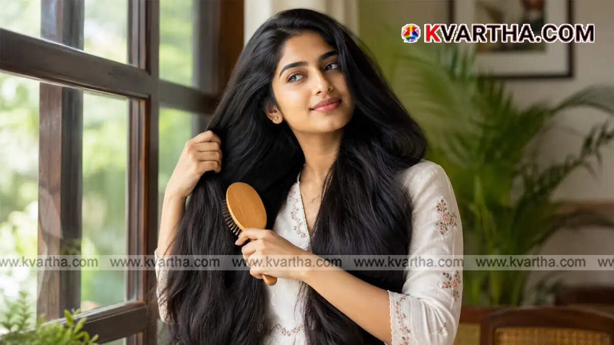 Woman carefully brushing her hair with a wooden comb