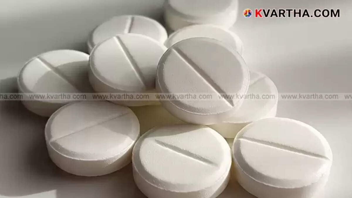 A paracetamol tablet broken in half, showing a metal piece embedded inside it.