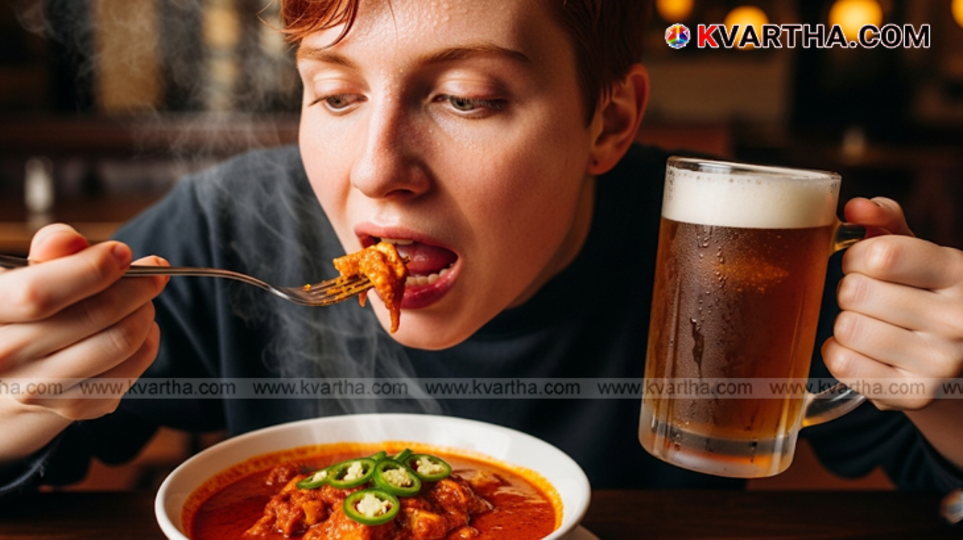 Spicy chicken wings and a glass of alcohol.