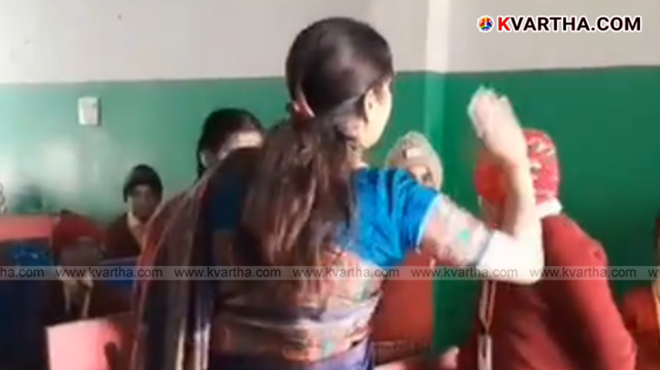 Image from the viral video showing the teacher hitting students in UP.