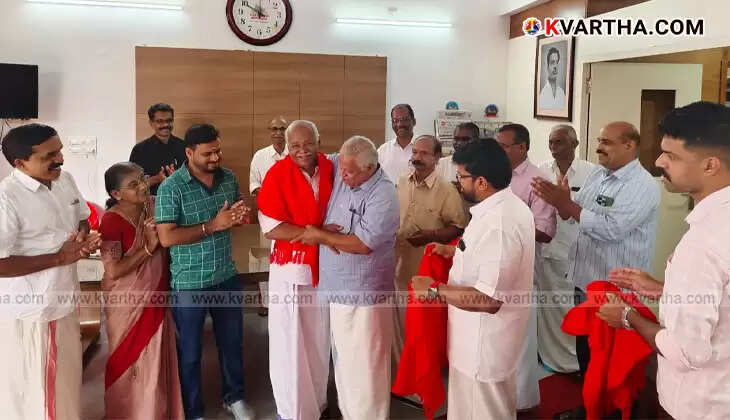 K.V. Raveendran, a former Congress leader, being welcomed into the CPI(M) by party leaders in Kannur.