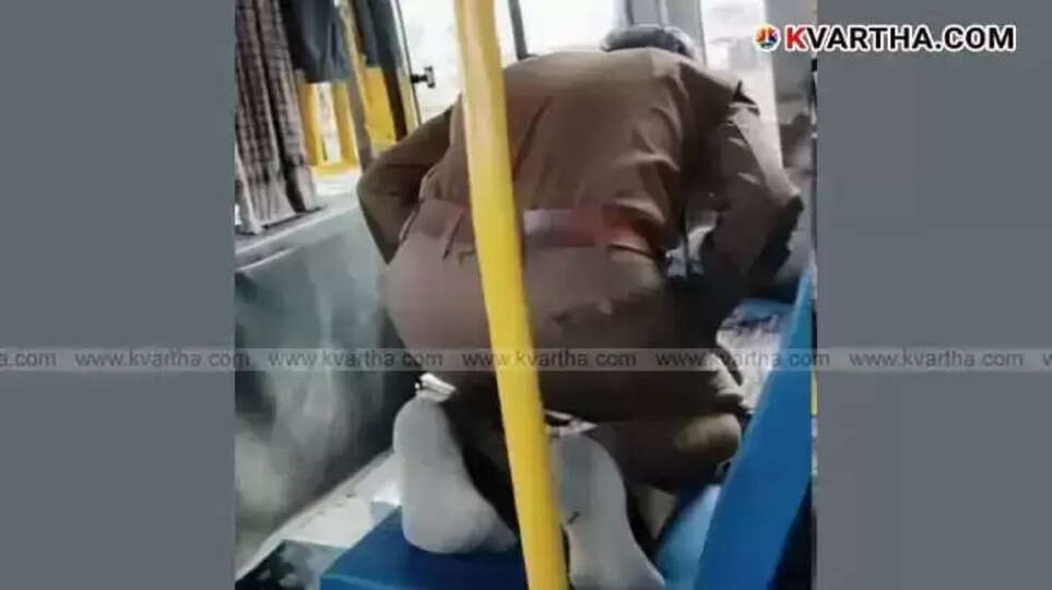 KSRTC bus driver offering prayers while seated in the passenger seat.